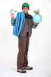 Construction worker holding a globe and a wad of bills