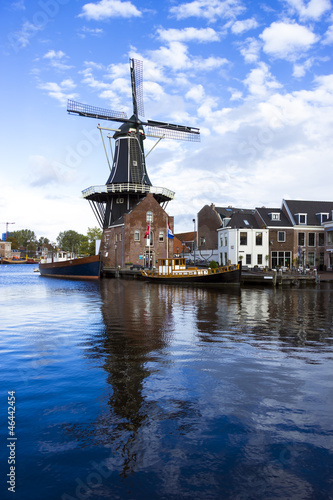 Photo: Picturesque landscape with windmill. Haarlem, Holland Picturesque landscape with windmill. Haarlem, Holland