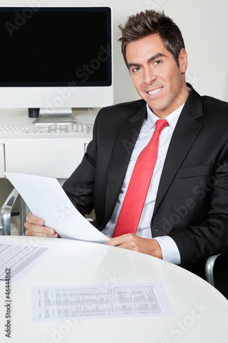 Photo: Happy Businessman Holding Document Happy Businessman Holding Document