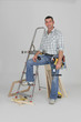 Tradesman posing with his building materials