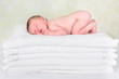 Baby on stack of towels