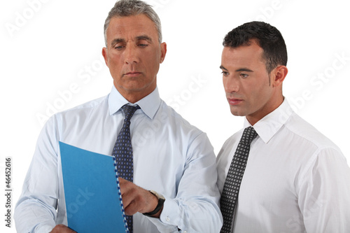 Photo: businessman showing a report to a colleague businessman showing a report to a colleague