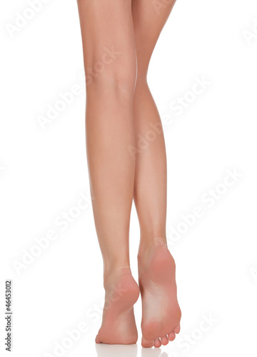 Photo: Female legs with pink heels isolated on white background Female legs with pink heels isolated on white background