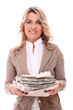 Beautiful mid aged woman in office suit with newspapers in hands
