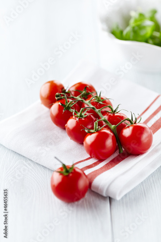 Photo: Cherry tomatoes on white kitchen towel Cherry tomatoes on white kitchen towel