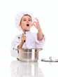 Photo: Little singing boy chef in uniform with ladle stiring in the pot Little singing boy chef in uniform with ladle stiring in the pot