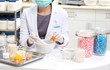A pharmacist preparing medication with mortar
