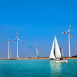 Yacht in the sea and wind turbines.