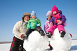 Happy family making snowman