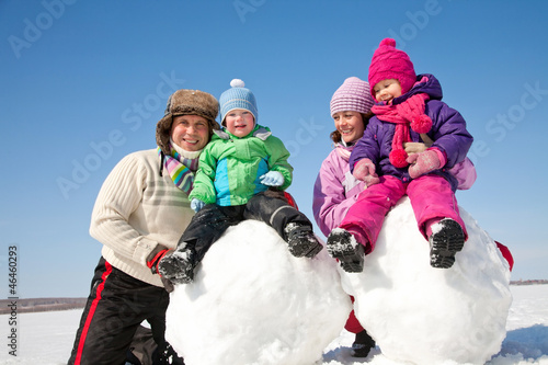 Photo: Happy family making snowman Happy family making snowman