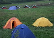 campsite with many tents in the middle of the lawn