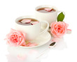 cups of tea with roses isolated on white