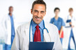 Smiling doctor in front of his team