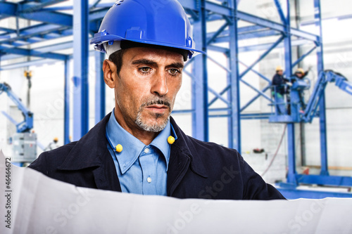 Photo: Engineer reading a blueprint Engineer reading a blueprint