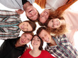 Photo: Low angle view of business people with their heads together Low angle view of business people with their heads together
