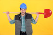 Scowling labourer carrying a shovel