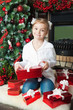 Little girl with gifts near christmas tree