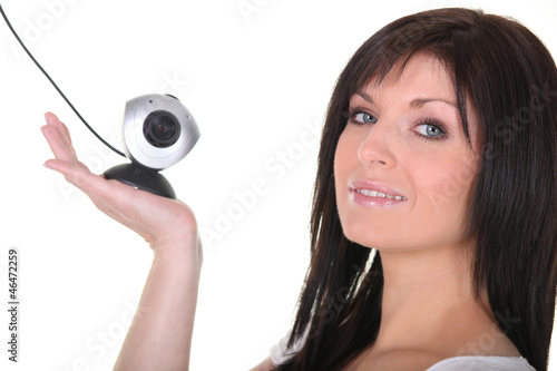 Photo: Woman holding web cam Woman holding web cam