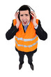 Man covering his ears with earmuffs