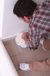 Oblique image of a man laying carpet