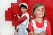 Photo: Kids painting wall with roller Kids painting wall with roller
