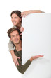 Couple stood by blank message board