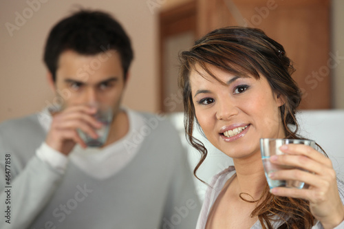 Photo: couple drinking glass of water couple drinking glass of water
