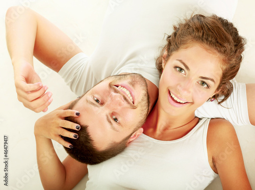 Photo: young lovely couple lying on the floor young lovely couple lying on the floor