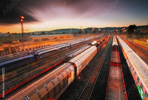 Photo: Cargo train platform at sunset with container Cargo train platform at sunset with container
