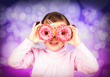 Photo: Girl looks through donuts Girl looks through donuts
