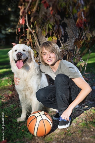 Photo: Boy with his dog in the park Boy with his dog in the park