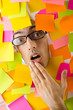 Man's face through paper and reminders