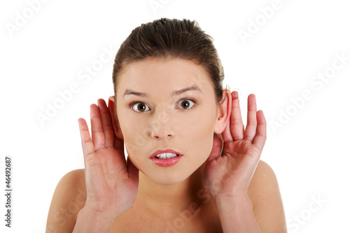 Photo: Surprised woman trying to listening a gossip Surprised woman trying to listening a gossip