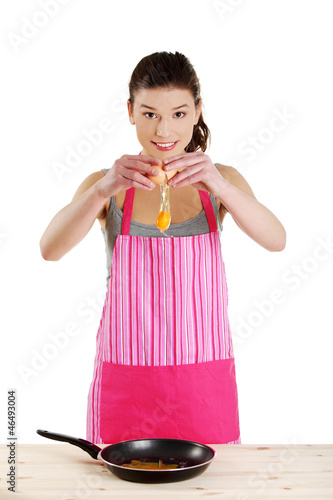Photo: Young woman cooking healthy food Young woman cooking healthy food