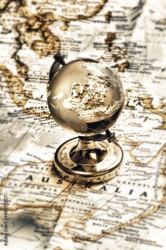 Photo: Old fashioned earth glass globe on the vintage map Old fashioned earth glass globe on the vintage map