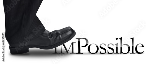 Photo: Business Man Stepping on Impossible Text Business Man Stepping on Impossible Text