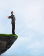 Businessman standing on the cliff