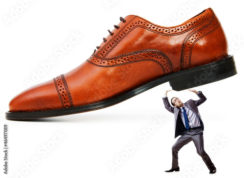 Photo: Woman domination concept with shoes and man Woman domination concept with shoes and man