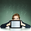 Businesswoman with doubts showing surprised her tablet computer