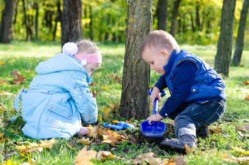Photo: Brother ans sister digging with a trowel Brother ans sister digging with a trowel
