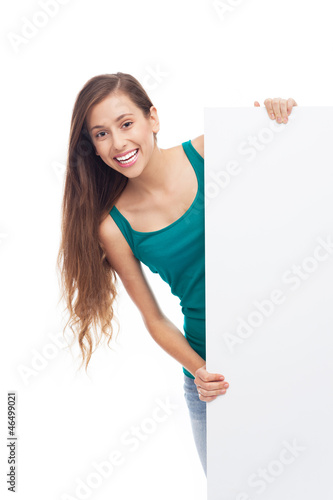 Photo: Young woman with blank poster Young woman with blank poster