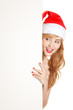 Xmas pretty woman peeking from behind blank sign billboard isola