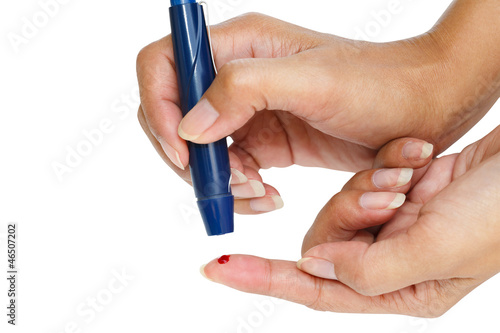 Photo: Diabetic lancet device in hand Diabetic lancet device in hand