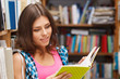 Beautiful female student in a library