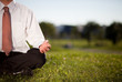 Photo: Businessman meditating in a park Businessman meditating in a park