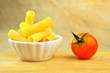 Raw tortiglioni pasta in a small bowl, selective focus