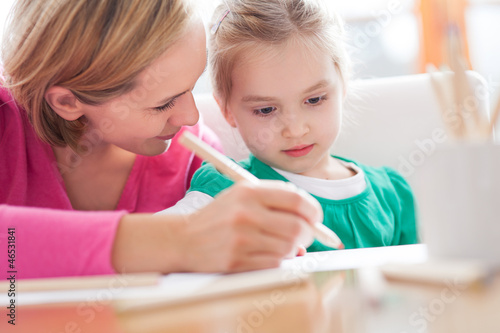 Photo: Mother and daughter writing together Mother and daughter writing together