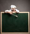chef holding green chalkboard