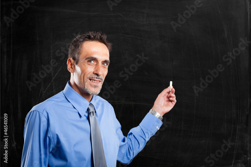 Photo: Man showing an empty blackboard Man showing an empty blackboard