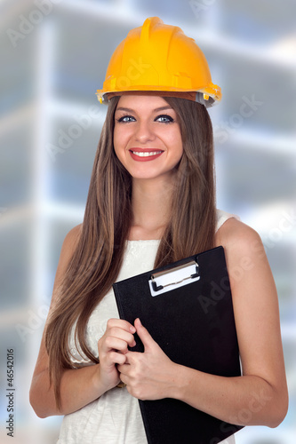 Photo: Attractive architect with blue eyes and yellow helmet Attractive architect with blue eyes and yellow helmet